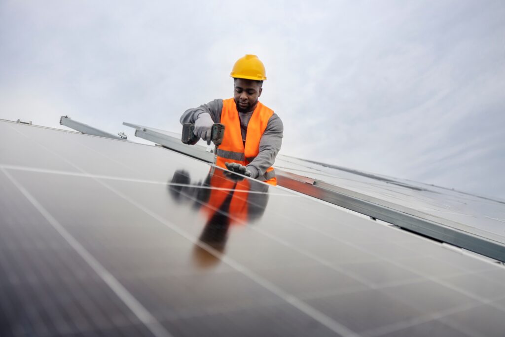 man-installing-solar-panels-neighborhood