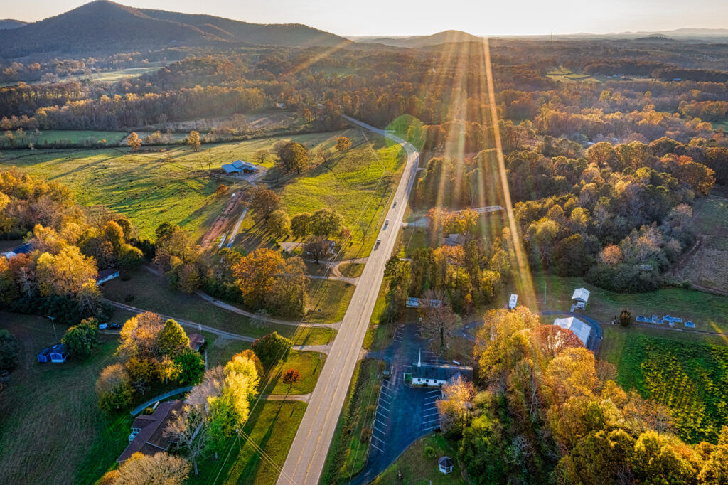 Aerial shot of backlit road in Georgia Mountains during the sunset in the Fall season